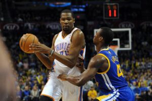 Nov 29, 2013; Oklahoma City, OK, USA; Oklahoma City Thunder small forward Kevin Durant (35) handles the ball against Golden State Warriors small forward Harrison Barnes (40) during the third quarter at Chesapeake Energy Arena. Mandatory Credit: Mark D. Smith-USA TODAY Sports