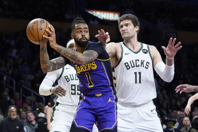 March 8th, 2024; Los Angeles, California, USA; Milwaukee Bucks center Brook Lopez defends Los Angeles Lakers point guard D'Angelo Russell at Crypto.com Arena. Mandatory Credit: Kiyoshi Mio-USA TODAY Sports