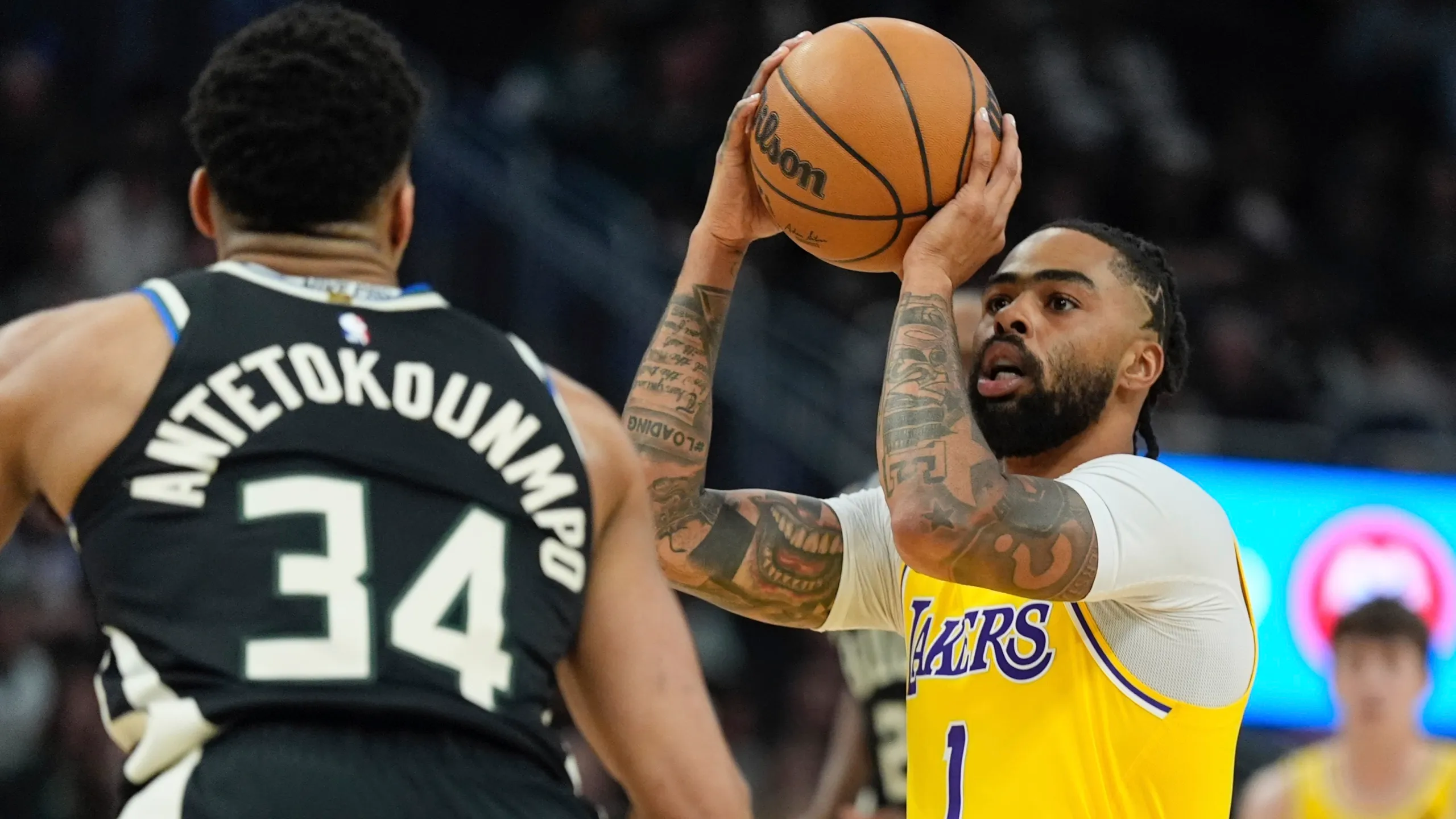 March 26, 2024; Milwaukee, Wisconsin, USA; Los Angeles Lakers guard D'Angelo Russell takes jumper against Milwaukee Bucks at Fiserv Forum. Mandatory Credit: Michael McLoone-USA TODAY Sports