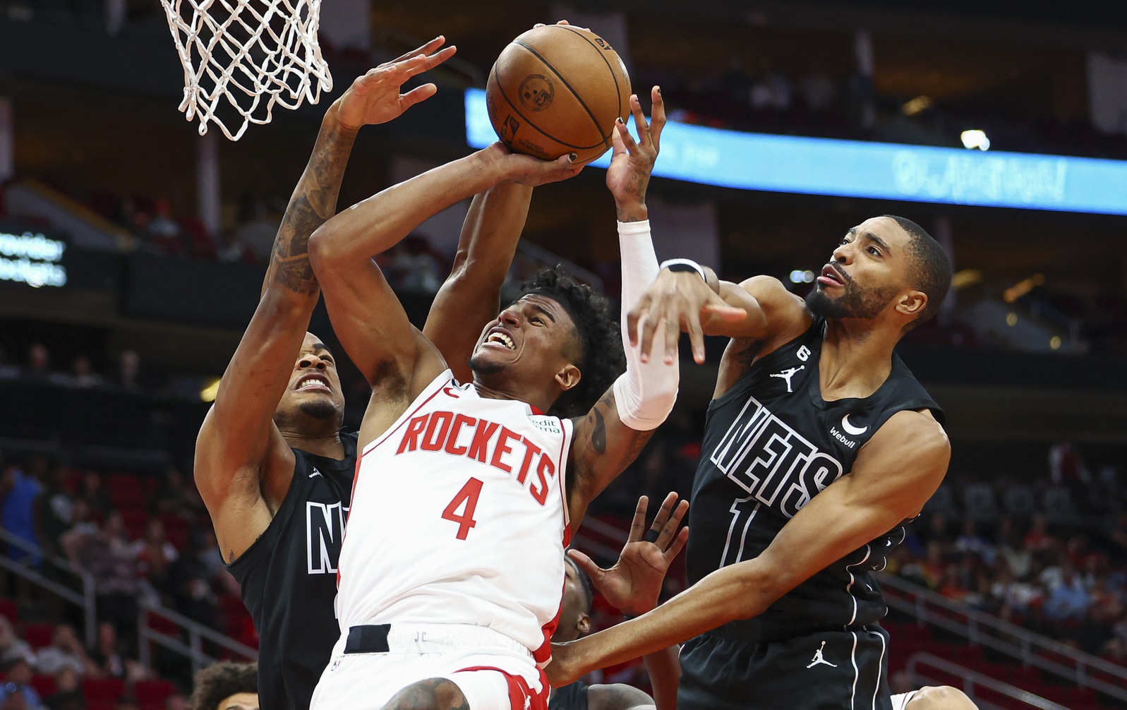 Mar 7, 2023; Houston, Texas, USA; Houston Rockets guard Jalen Green (4) attempts to score as Brooklyn Nets center Nic Claxton (33) and forward Mikal Bridges (1) defend during the first quarter at Toyota Center. Mandatory Credit: Troy Taormina-USA TODAY Sports