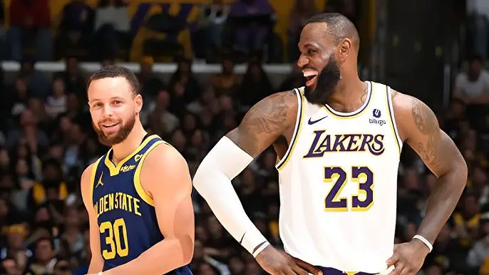 March 16th 2024; Los Angeles, California, USA; Los Angeles Lakers forward LeBron James laughs with Steph Curry at Crypto.com Arena on Saturday night. Mandatory Credit: Adam Pantozzi-Getty Images