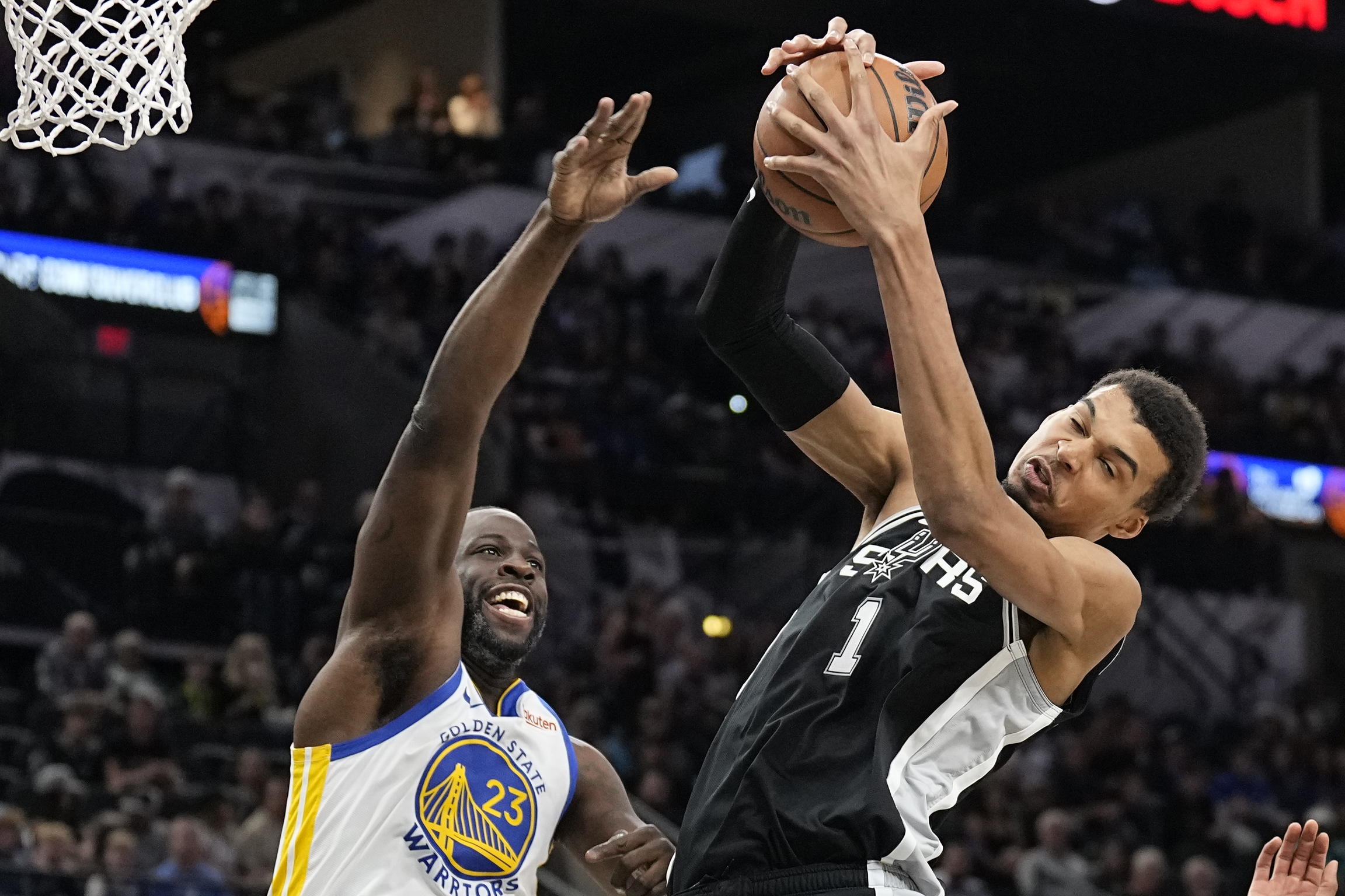 Mar 11, 2024; San Antonio, Texas, USA; San Antonio Spurs forward Victor Wembanyama (1) grabs a rebound away from Golden State Warriors forward Draymond Green (23) during the first half at Frost Bank Center. Mandatory Credit: Scott Wachter-USA TODAY Sports
