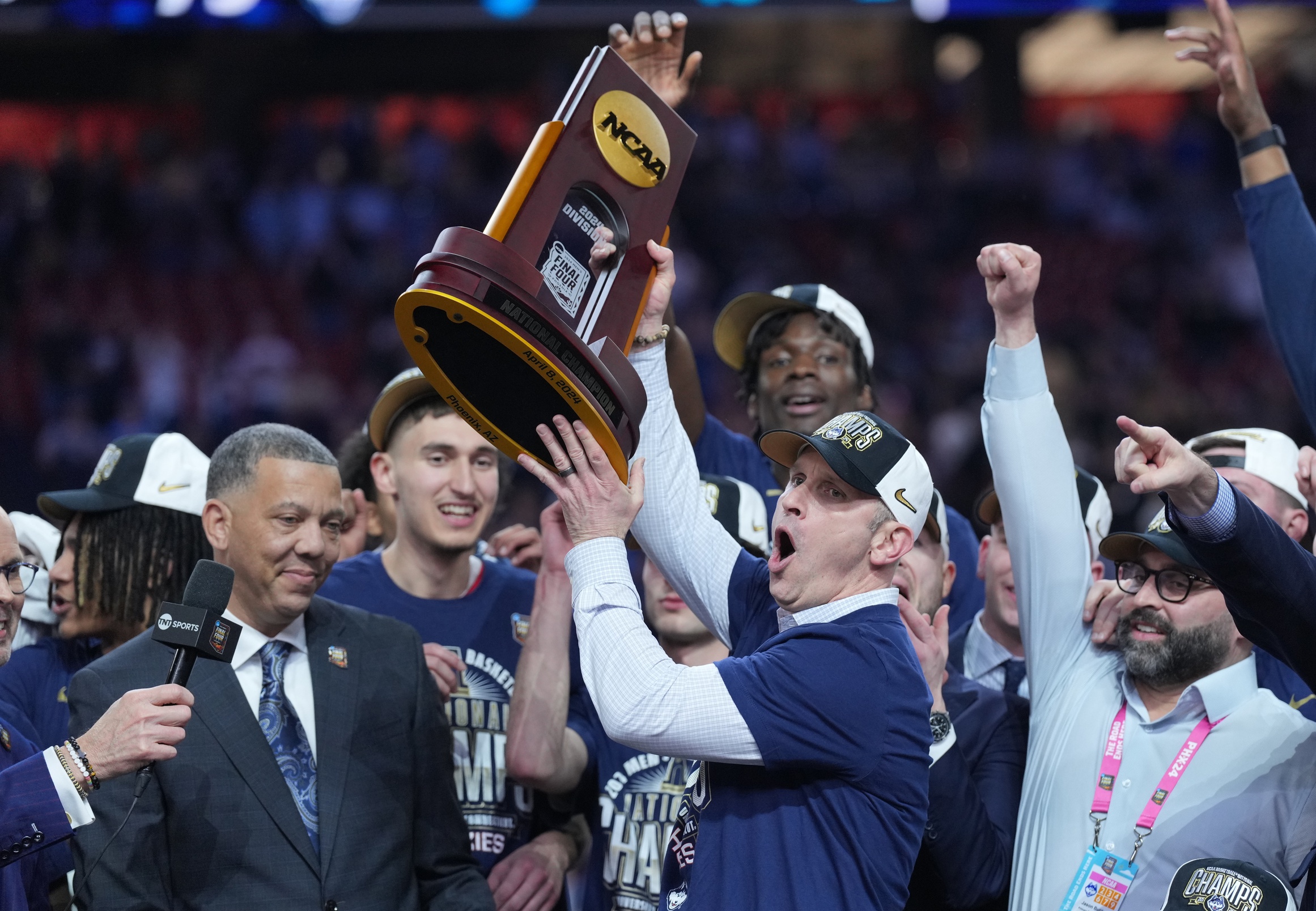 Apr 8, 2024; Glendale, AZ, USA; Connecticut Huskies head coach Dan Hurley hoists the championship trophy after defeating the Purdue Boilermakers in the national championship game of the Final Four of the 2024 NCAA Tournament at State Farm Stadium. Mandatory Credit: Robert Deutsch-USA TODAY Sports