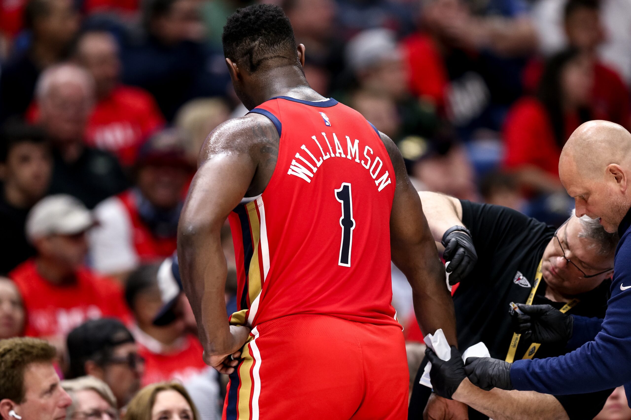 Apr 16, 2024; New Orleans, Louisiana, USA; New Orleans Pelicans forward Zion Williamson (1) gets medical attention during the first half against the Los Angeles Lakers in a play-in game of the 2024 NBA playoffs against the New Orleans Pelicans at Smoothie King Center. Mandatory Credit: Stephen Lew-USA TODAY Sports