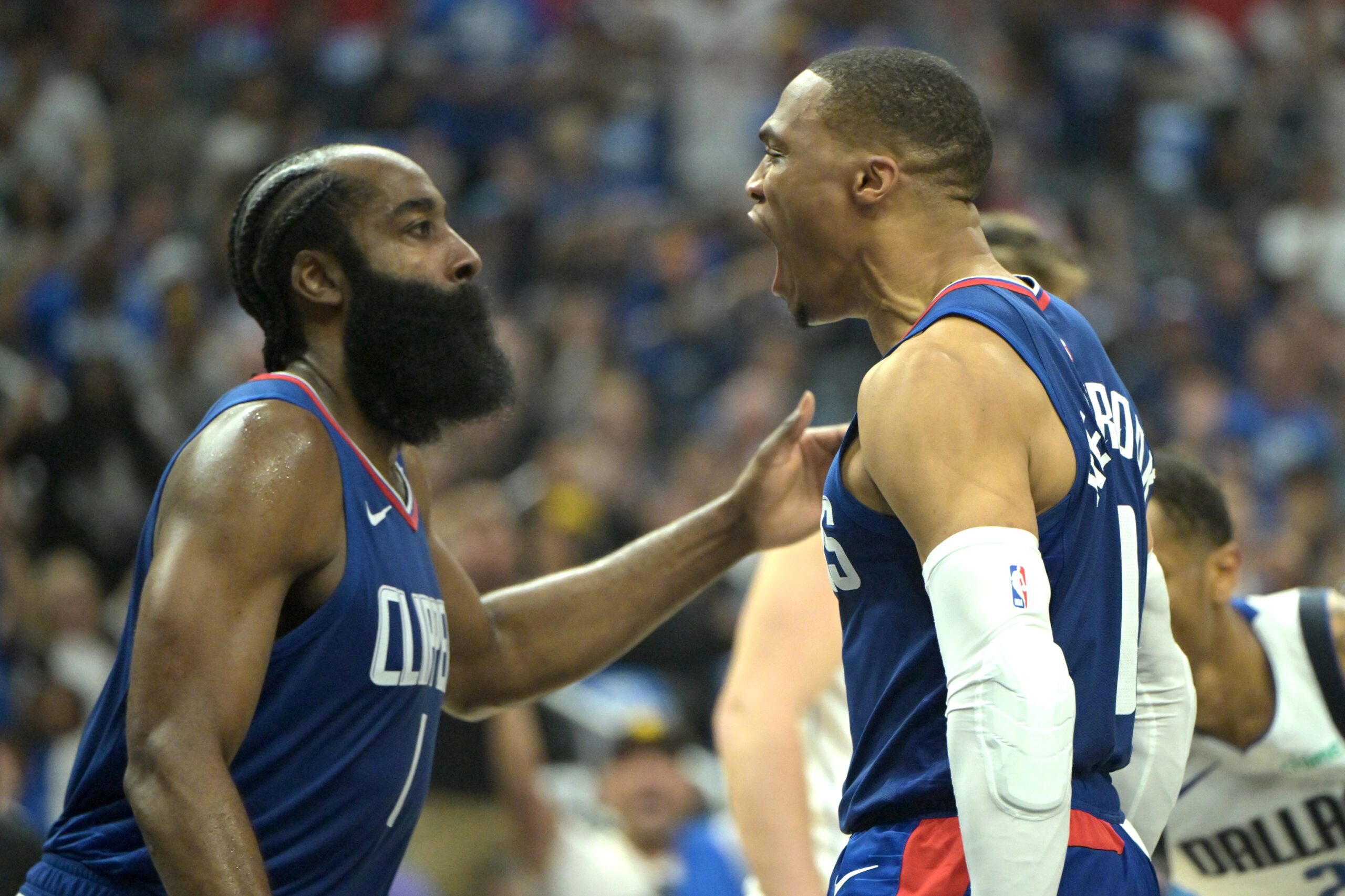 Apr 21, 2024; Los Angeles, California, USA; Los Angeles Clippers guard Russell Westbrook (0) celebrates after a dunk on a pass from guard James Harden (1) in the first half during game one of the first round for the 2024 NBA playoffs against the Dallas Mavericks at Crypto.com Arena. Mandatory Credit: Jayne Kamin-Oncea-USA TODAY Sports