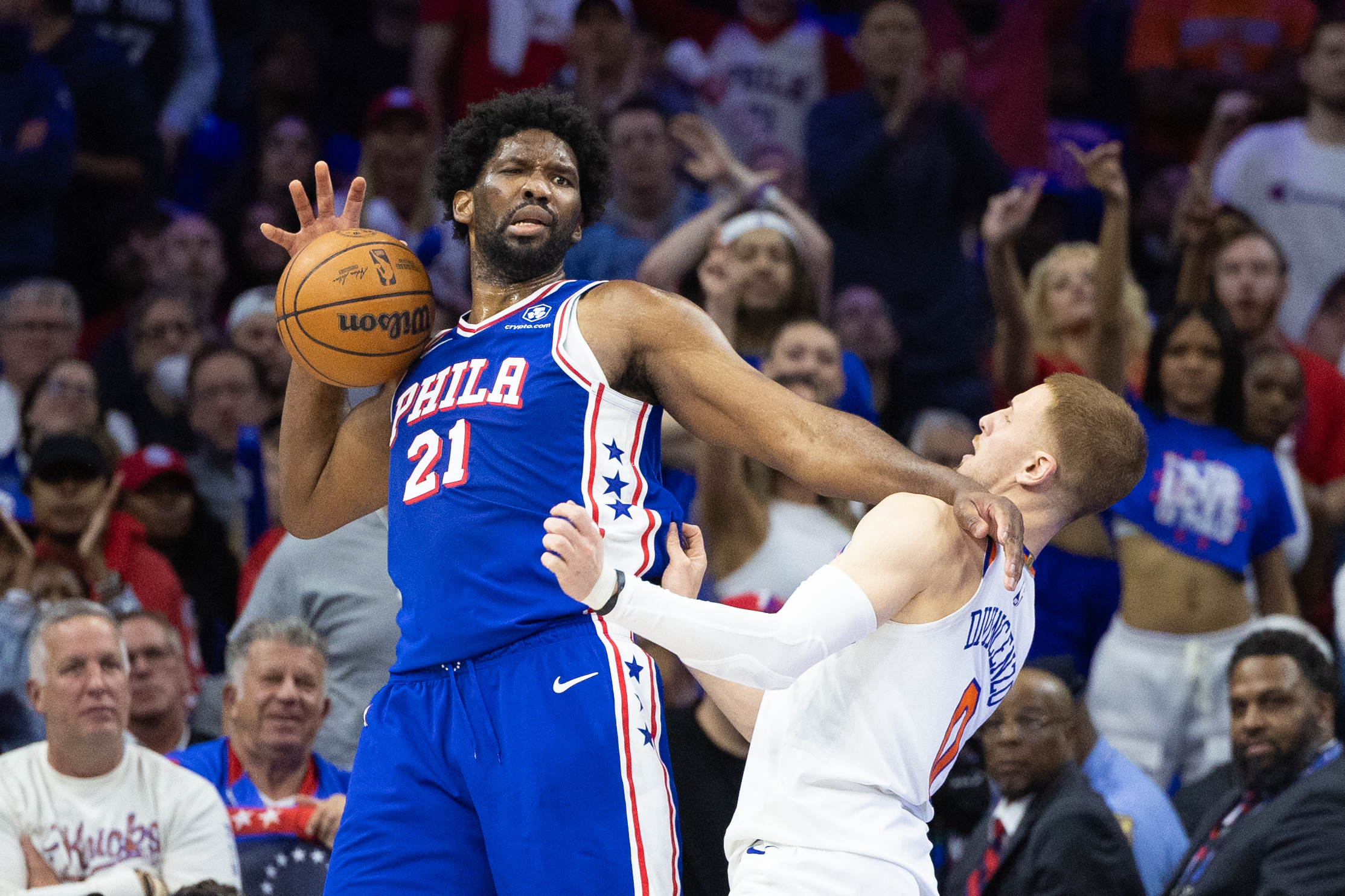 Apr 25, 2024; Philadelphia, Pennsylvania, USA; Philadelphia 76ers center Joel Embiid (21) is fouled by New York Knicks guard Donte DiVincenzo (0) during the second half of game three of the first round for the 2024 NBA playoffs at Wells Fargo Center. Mandatory Credit: Bill Streicher-USA TODAY Sports